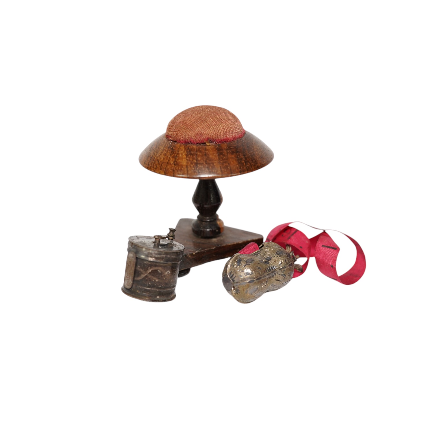Two early Victorian white metal tape measures and a rosewood miniature 'table' pin cushion. Condition - fair